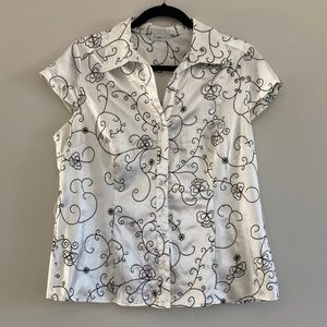 White silk top with black scrolling embellishments